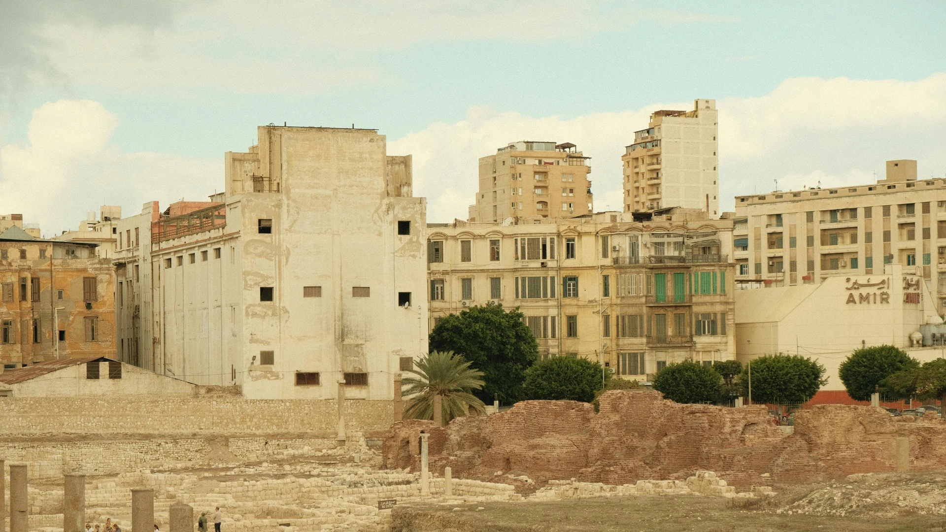 Alexandria, Egypt - View of ancient roman ruins against a modern urban backdrop, capturing history's blend with contemporary architecture.