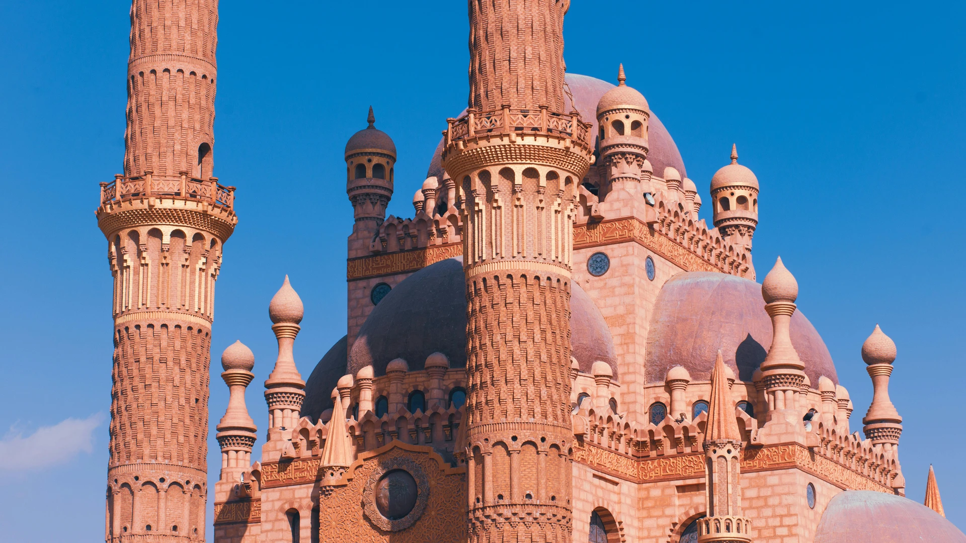 El Alamein, Egypt - Close-up of the sahaba mosque's intricate minarets against a clear blue sky in sharm el sheikh.