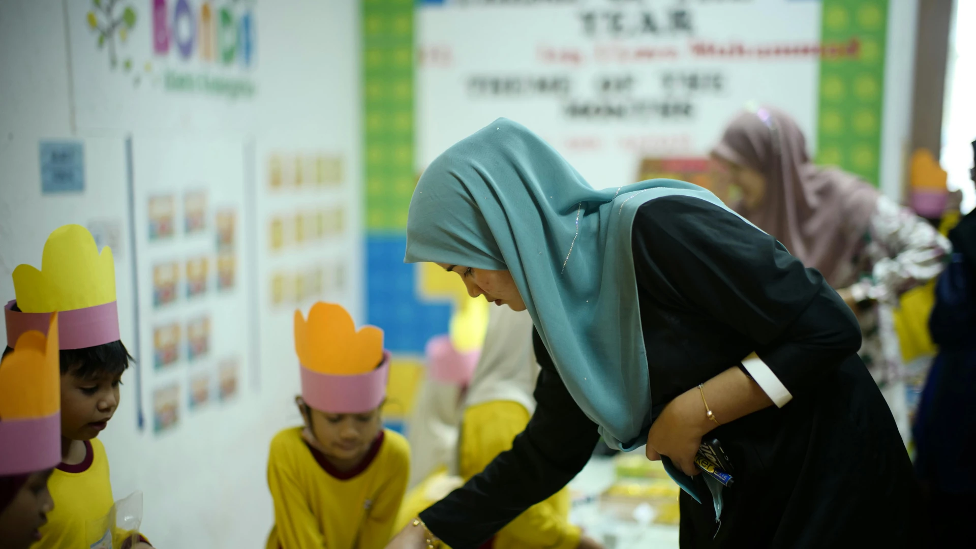 Marsa Alam, Egypt - Teacher guides young students in a classroom activity in shah alam, malaysia.