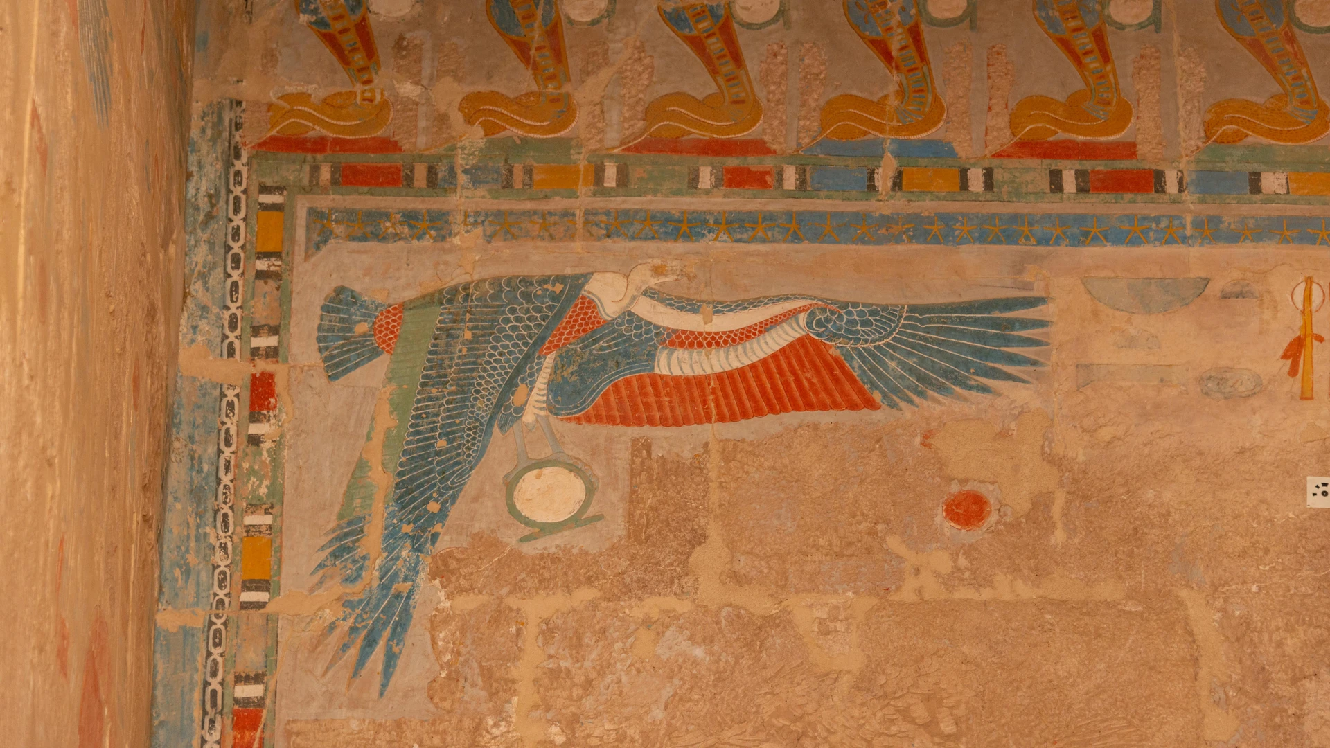 Sahl Hasheesh, Egypt - Detailed view of ancient egyptian hieroglyphs and colorful symbols on a sandstone wall, showcasing cultural artistry.