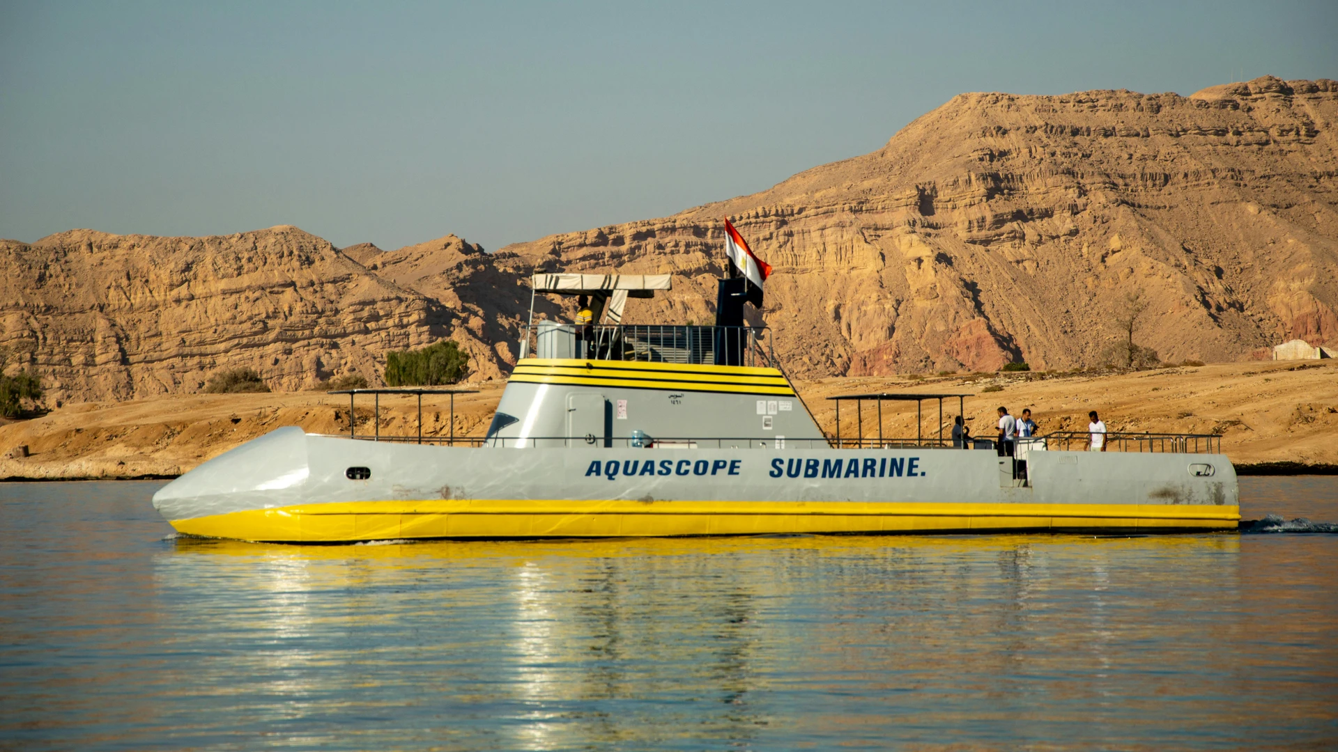 Soma Bay, Egypt - Vivid image of aquascope submarine sailing near rugged egyptian desert landscape. bright, clear day.