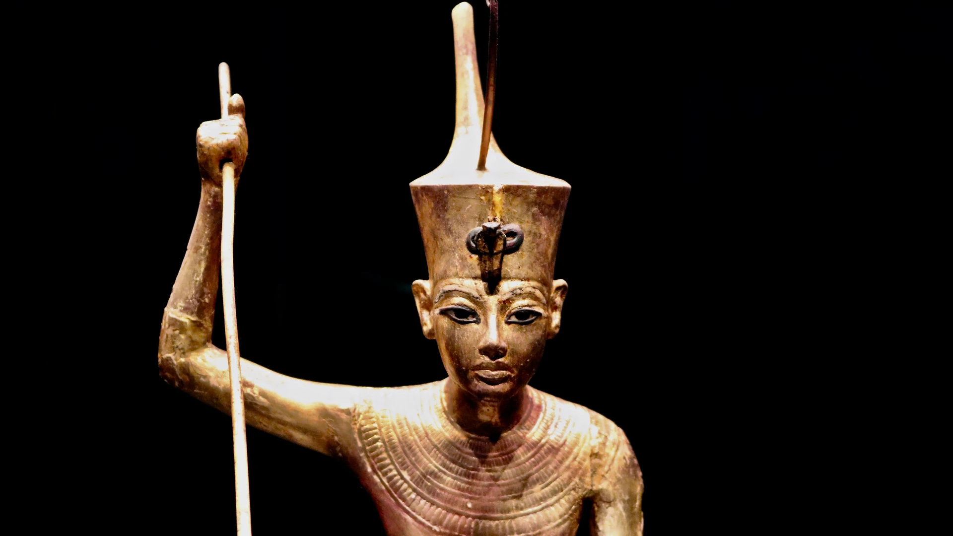 Soma Bay, Egypt - Close-up of an ancient egyptian pharaoh gold statue on a black background.