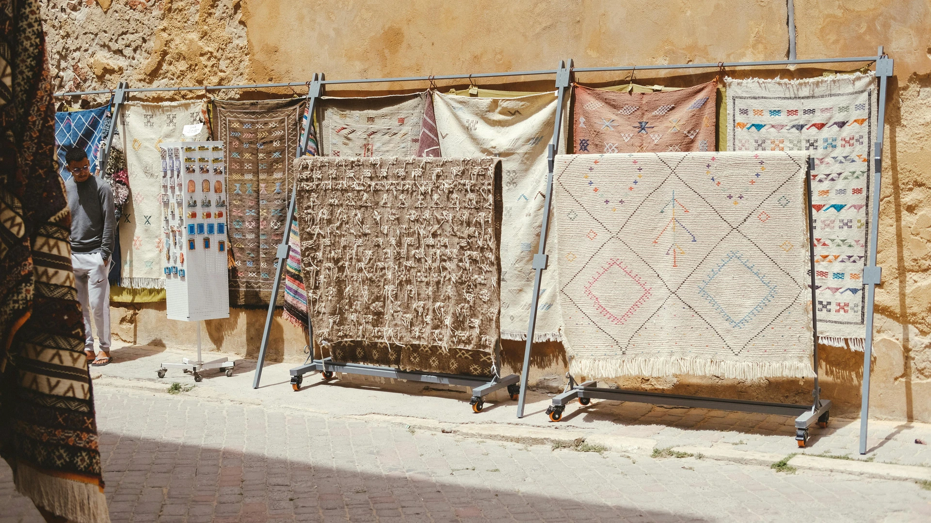 Aswan, Egypt - Traditional moroccan rugs on display against an ancient wall in el jadida, morocco.