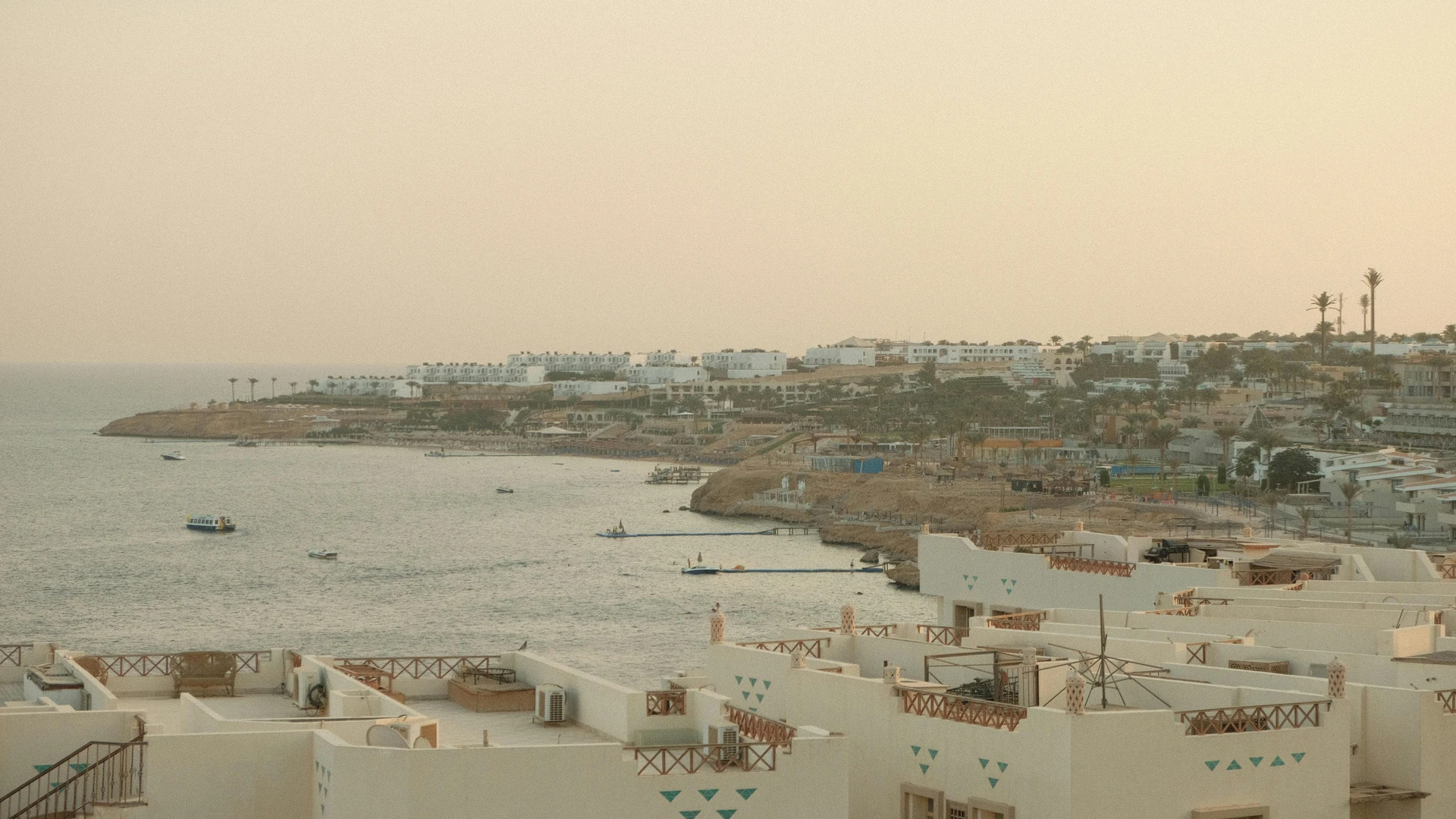 El Gouna, Egypt - Breathtaking view of sharm el sheikh coastline at sunset with calm sea and resort buildings.