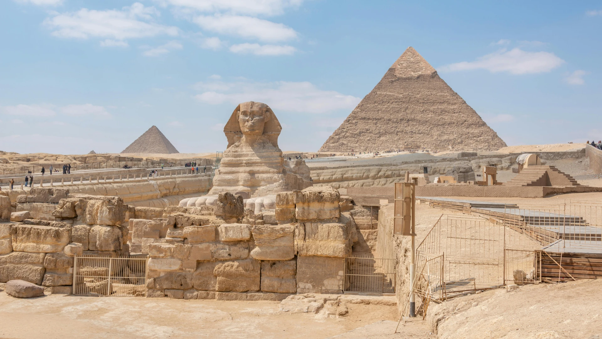 Giza, Egypt - Iconic view of the great sphinx and giza pyramids in egypt under a clear blue sky.
