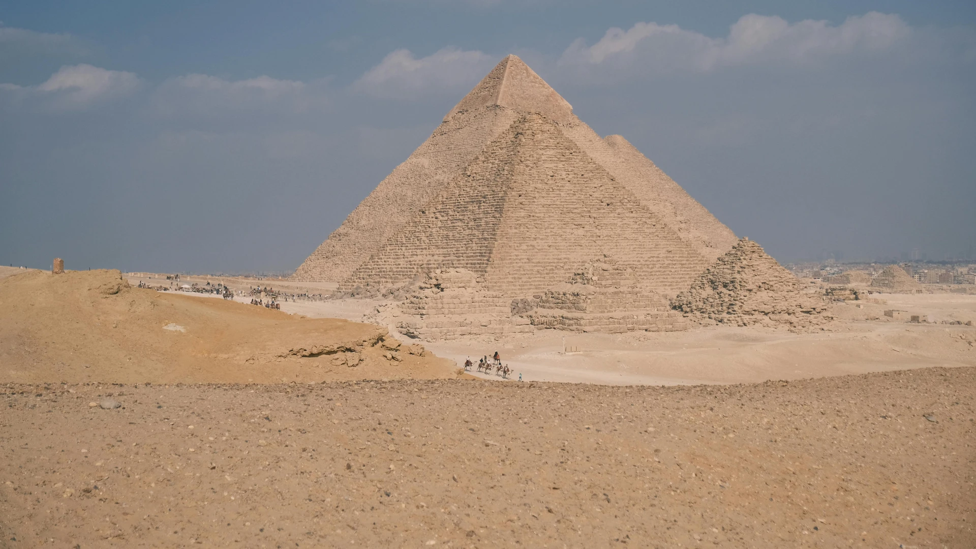 Giza, Egypt - Stunning daytime view of the iconic great pyramid of giza under a clear sky.