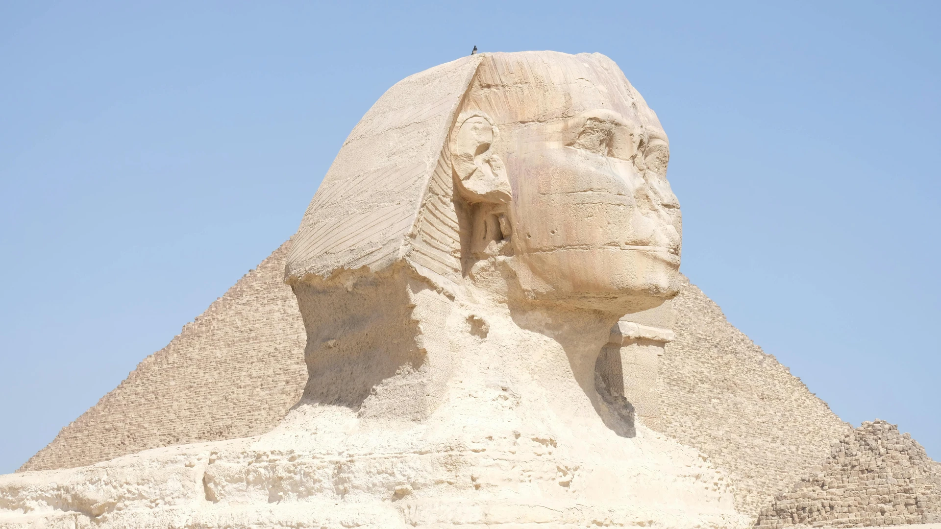 Giza, Egypt - Capture of the iconic great sphinx and pyramid under clear skies.