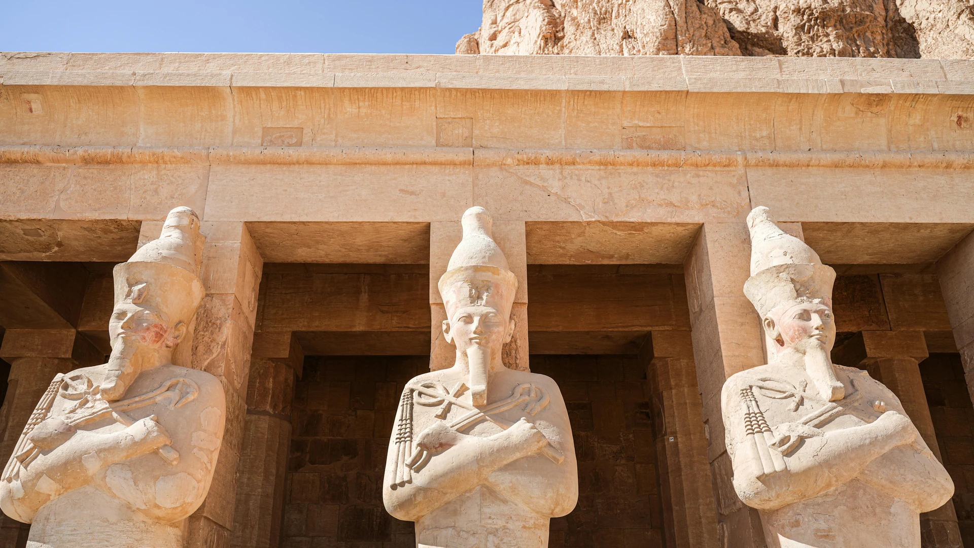 Luxor, Egypt - Three statues at hatshepsut's temple demonstrate ancient egyptian architecture.