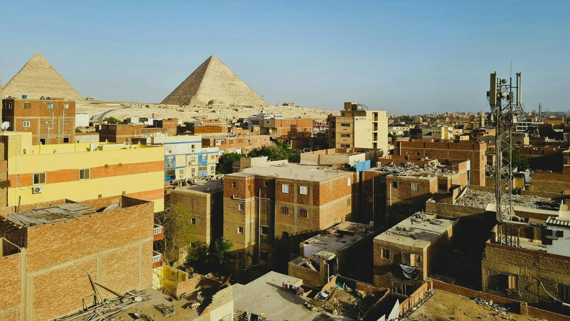 Safaga, Egypt - Great pyramids of giza rise above cityscape.