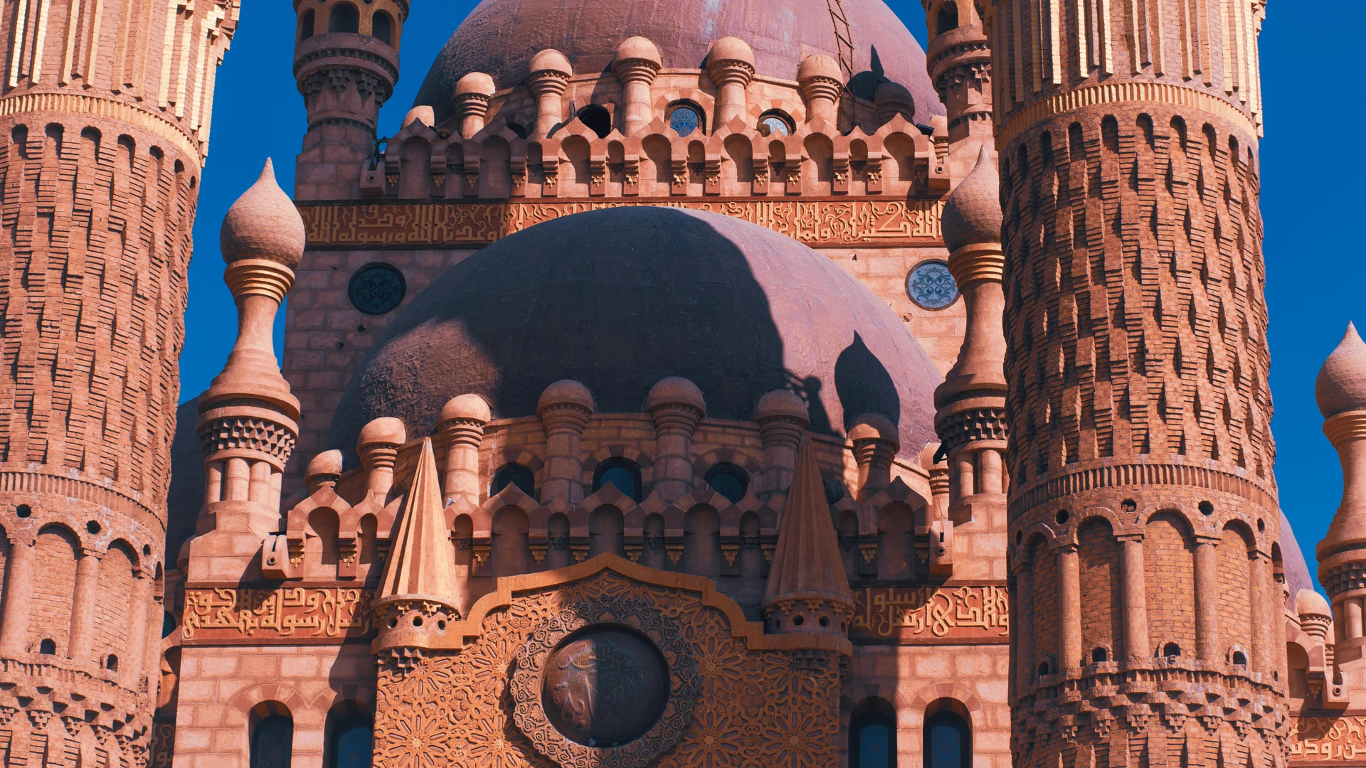 Sharm El Sheikh, Egypt - Close-up of the ornate sahaba mosque minarets and dome in sharm el sheikh under a clear blue sky.