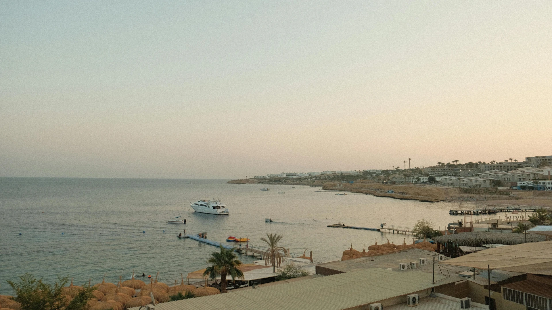 Sharm El Sheikh, Egypt - Tranquil sunset view of the sharm el sheikh coastline with a boat and tranquil waters.