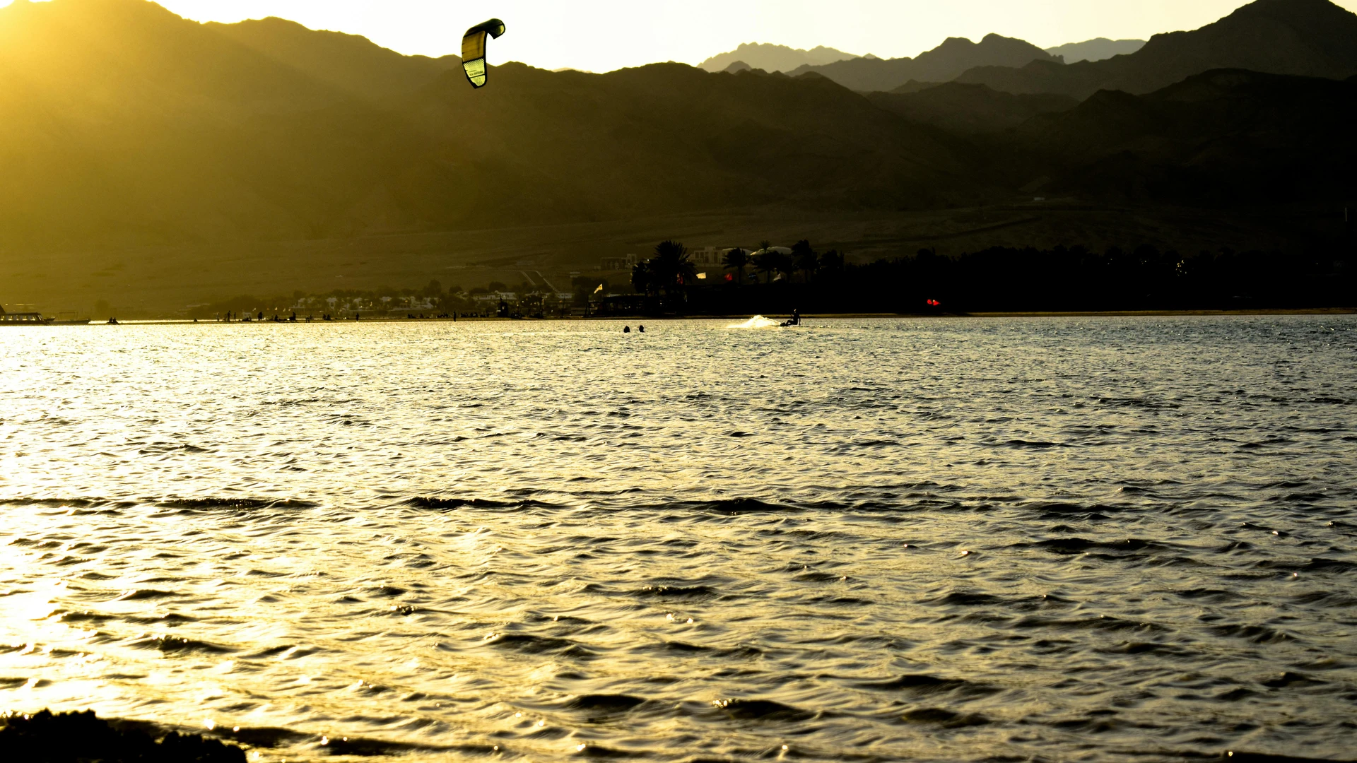 South Sinai, Egypt - Experience the thrill of kitesurfing during sunset in dahab, egypt, with stunning mountain views.