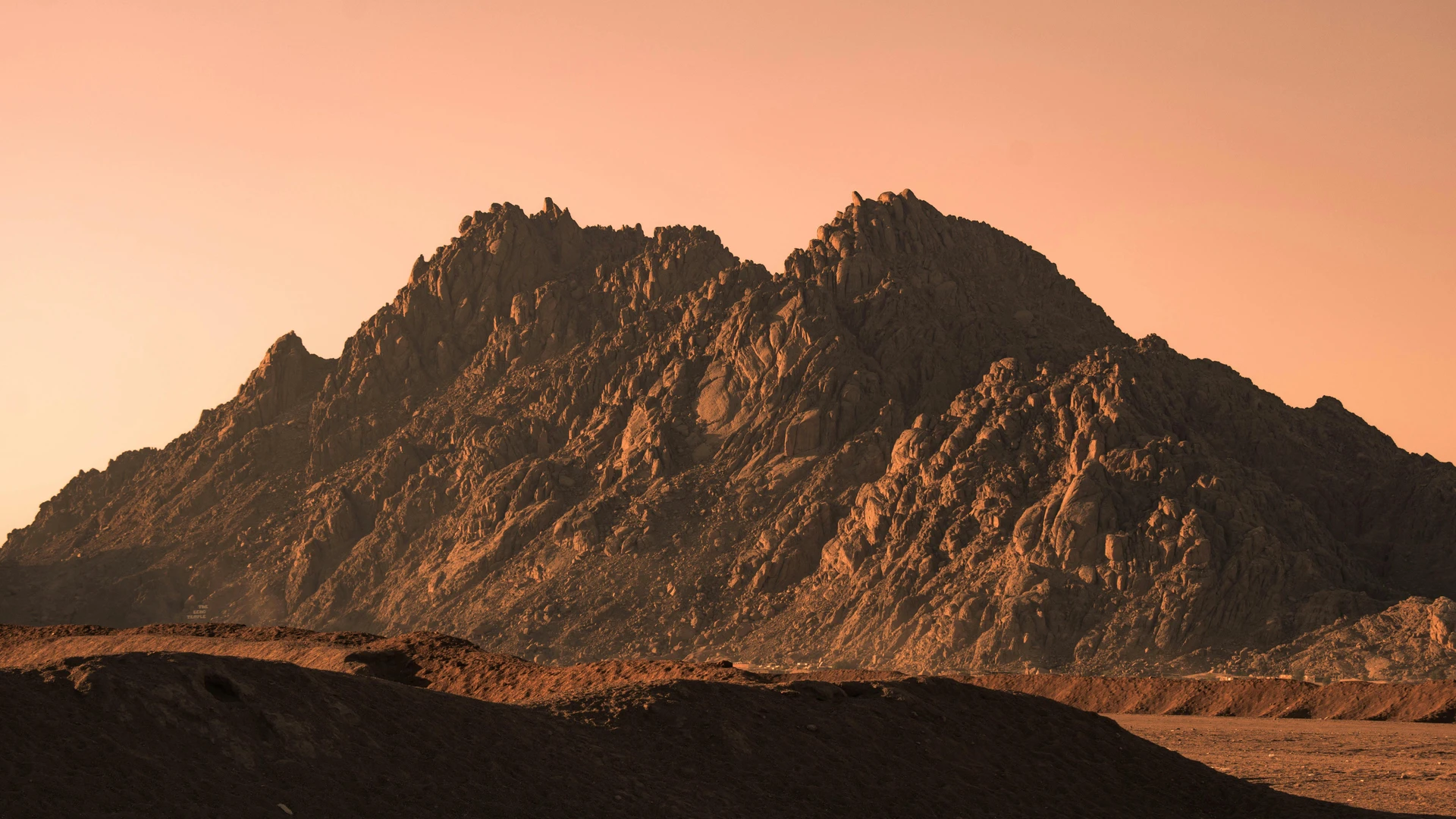 South Sinai, Egypt - Dramatic sunset view of rugged mountains in sharm el-sheikh, egypt, with warm hues.